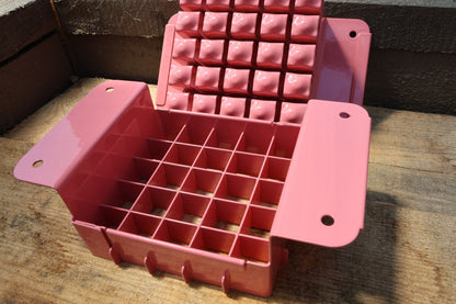 Nano 25 soil blocker in pink, open to show the 25-cell grid and the block-forming plate
