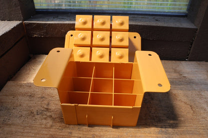 Nano 9 soil blocker in tangerine, open to show the 9-cell grid and the block-forming plate