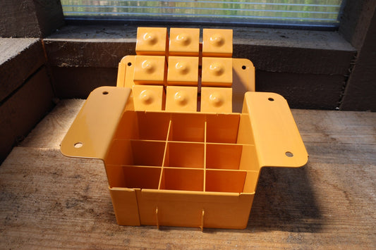 Nano 9 soil blocker in tangerine, open to show the 9-cell grid and the block-forming plate