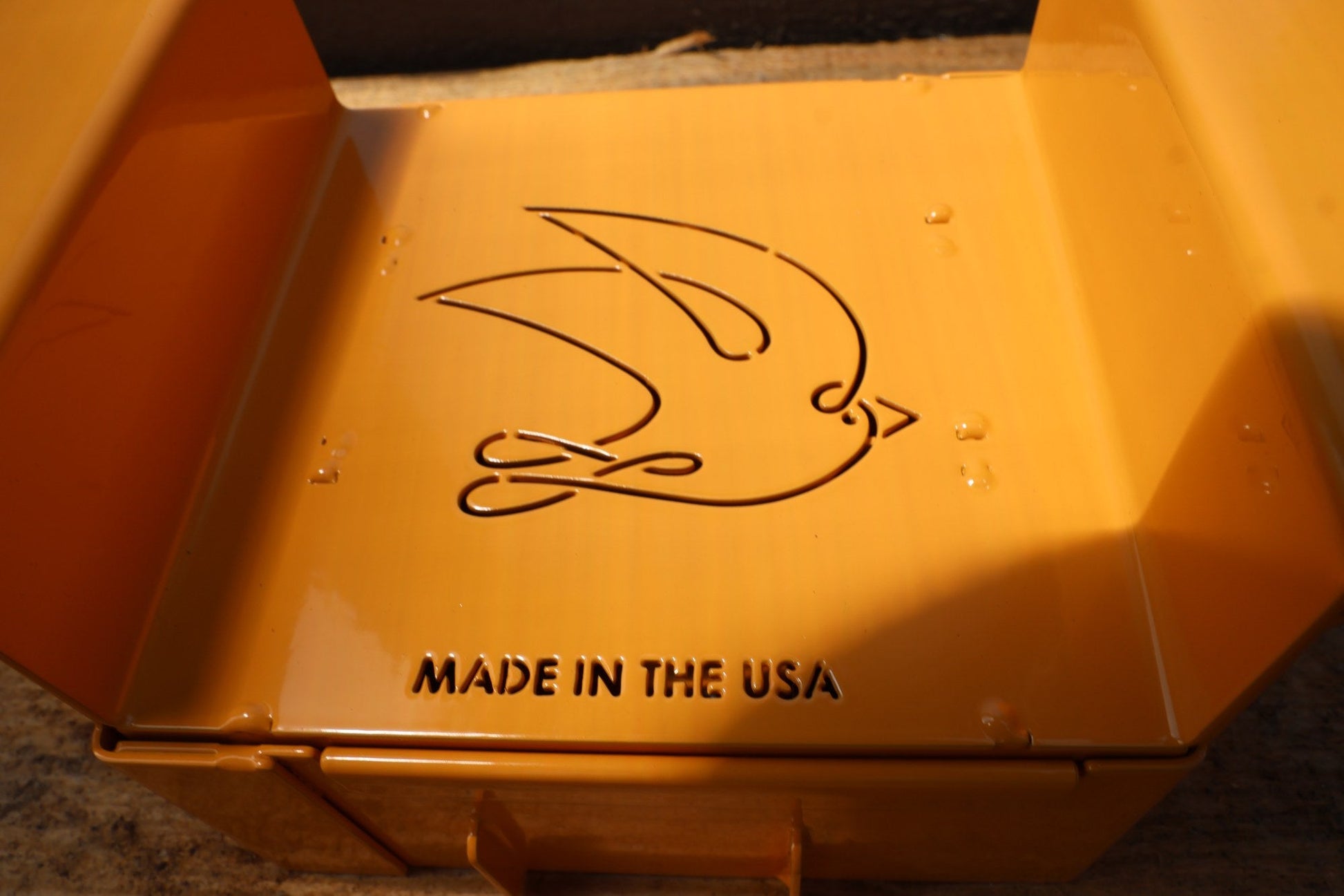 Close-up of the stamped swallow logo on the Nano 9 soil blocker