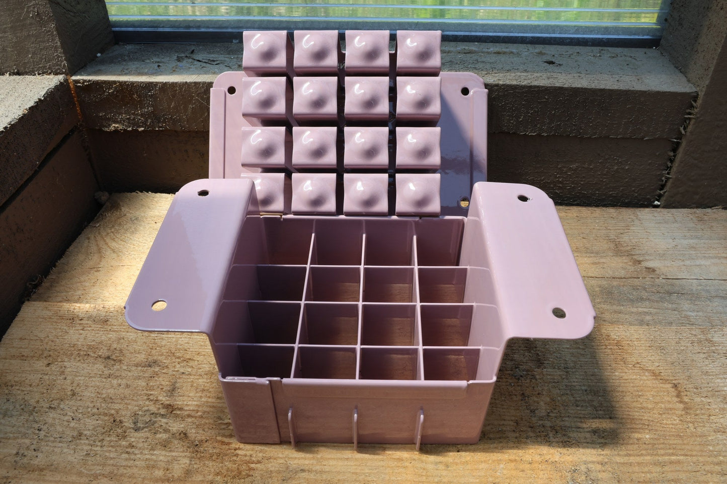 Nano 16 soil blocker in lavender, open to show the 16-cell grid and the block-forming plate