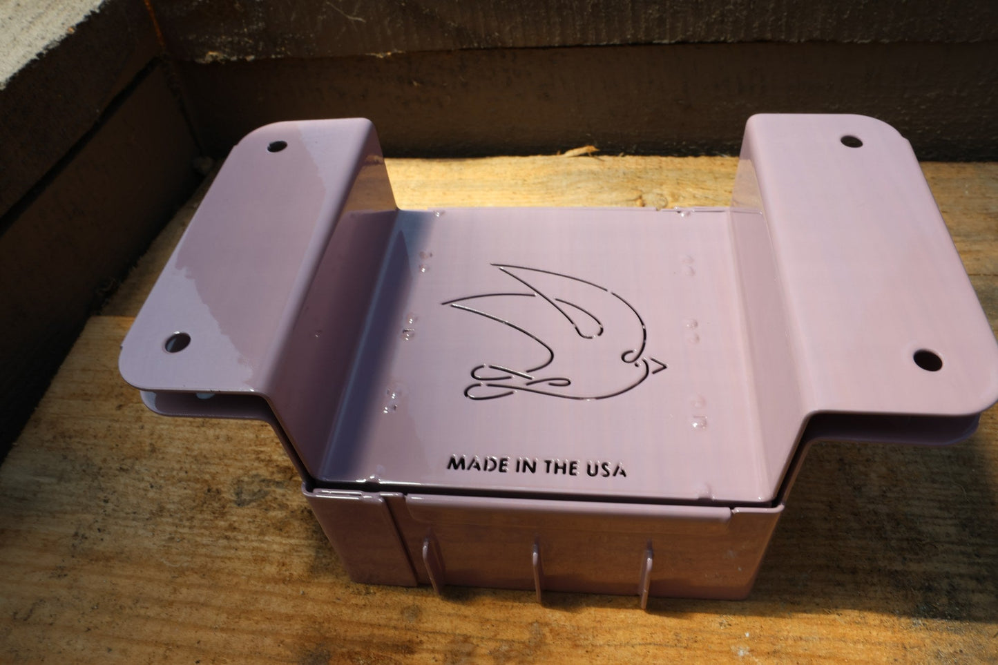 Lavender Nano 16 hand soil blocker closed, on a weathered wood bench