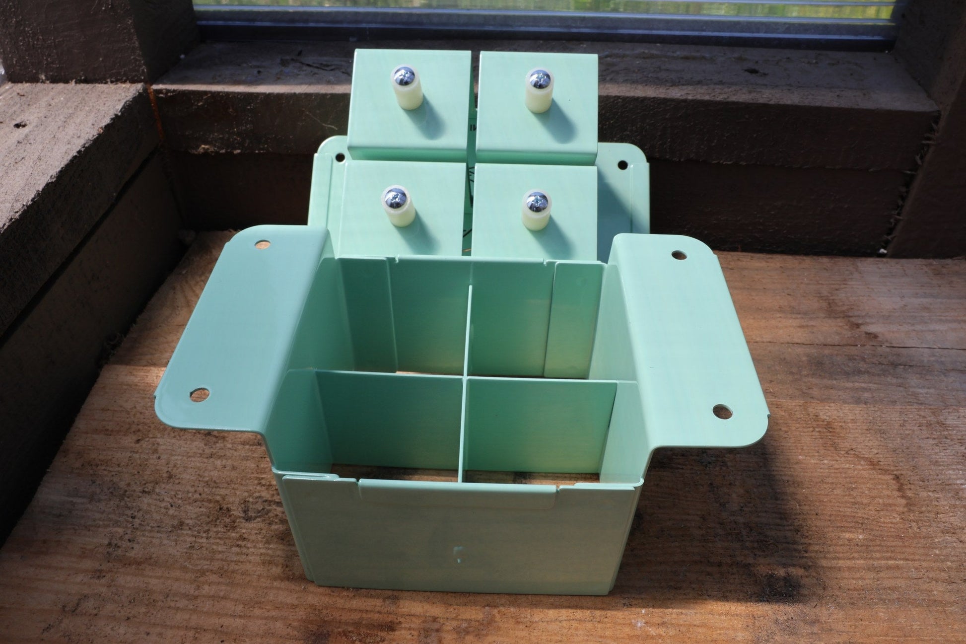 Angled view of the green Nano 4 with the large seed dibble plate raised