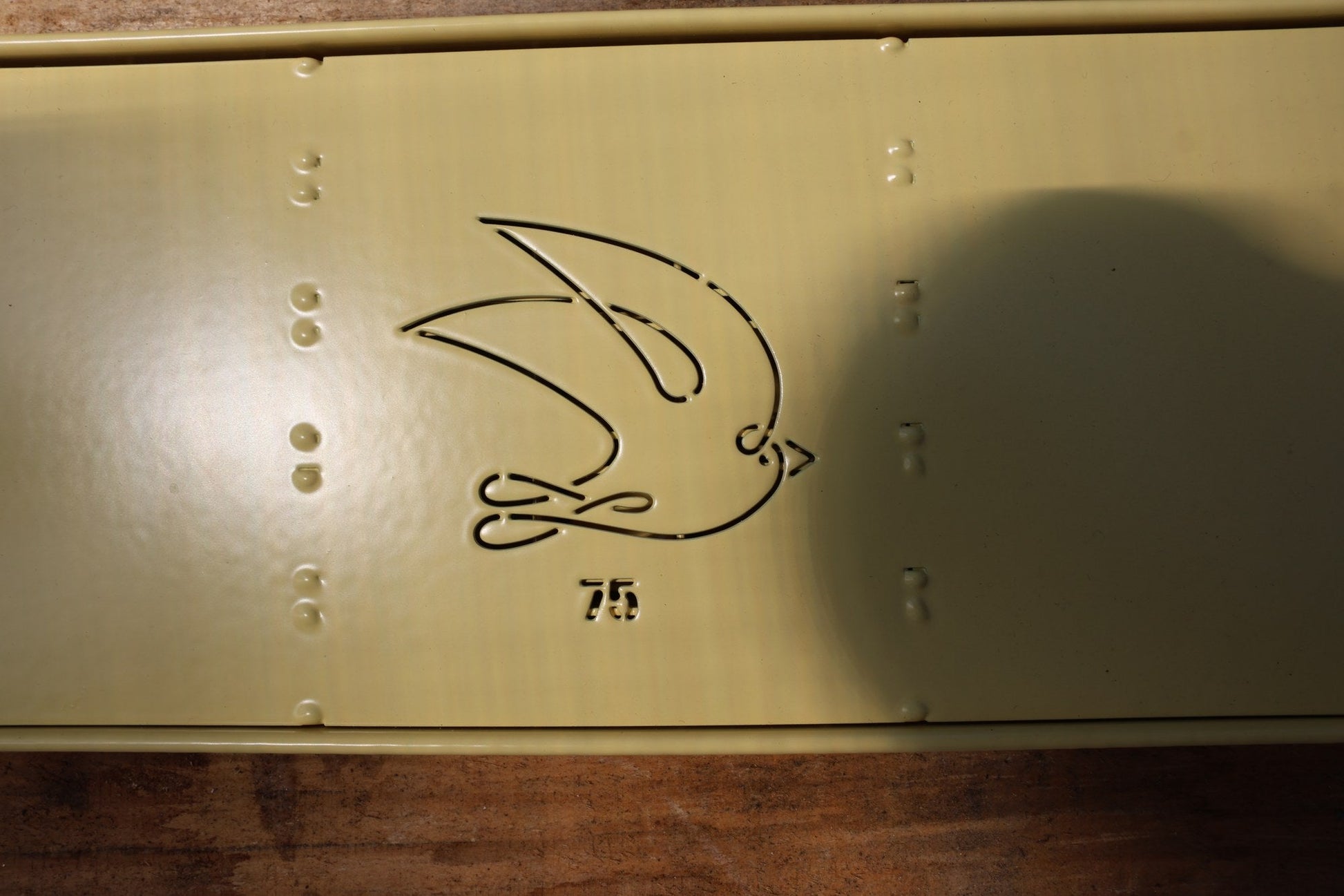 Close-up of the swallow logo and 75 stamp on the Swift Blocker Mini 75