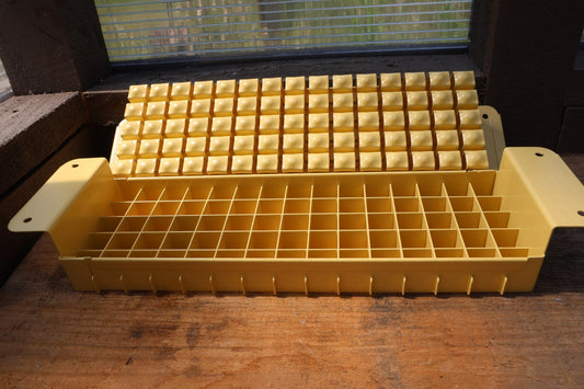Swift Blocker Mini 75 in yellow, open to show the 75-cell grid and the block-forming plate