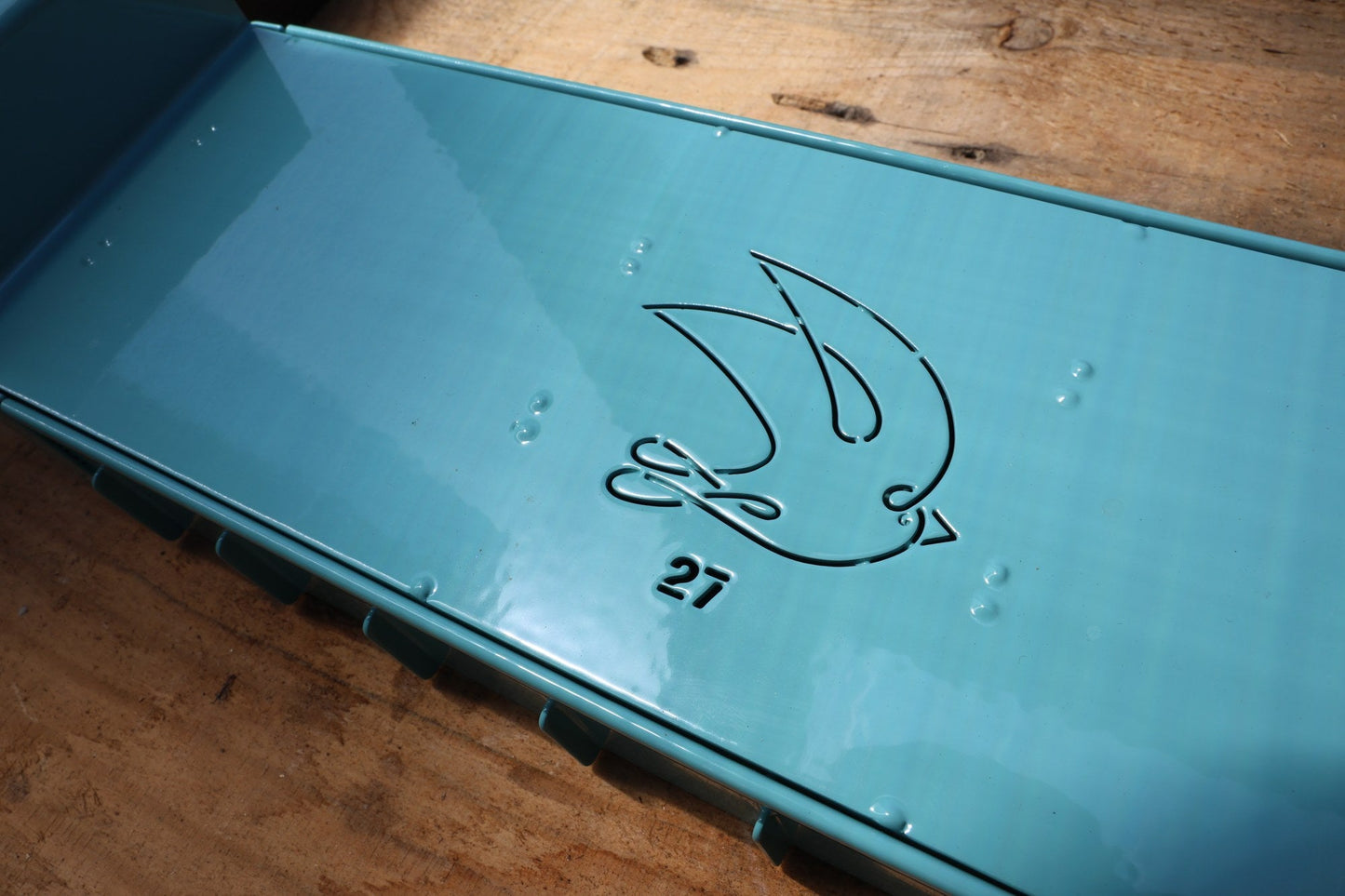 Close-up of the swallow logo and 27 stamp on the Swift Blocker Mini 27
